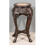 A Chinese Hardwood Circular Jardiniere Stand, inset with pink veined marble top, the whole carved