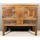 An Old Panelled Oak Aumbry of "16th Century" Design, with plain top and panelled front, fitted