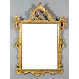 An Italian Carved Gilt Wood Framed Rectangular Wall Mirror of "18th Century" Design, with bold
