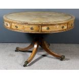 A George III Mahogany Circular Drum Table, the top inset with tooled leather central panel within