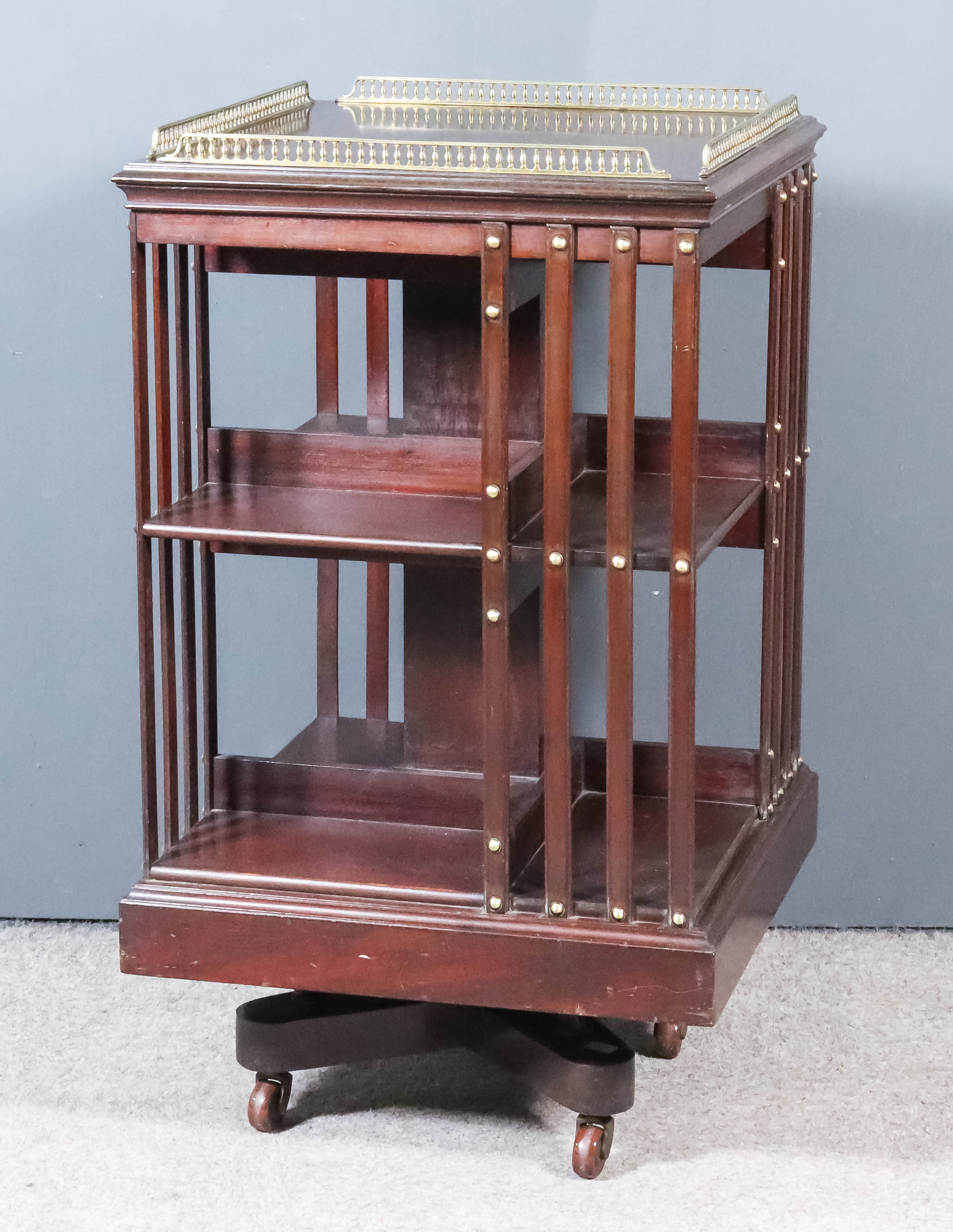 An Early 20th Century Mahogany Square Revolving Bookcase, with brass gallery with baluster turned