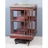 An Early 20th Century Mahogany Square Revolving Bookcase, with brass gallery with baluster turned