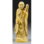 I* A Japanese Carved Ivory Okimono, Meiji Period, of a standing male figure with fly whisk, 8ins (