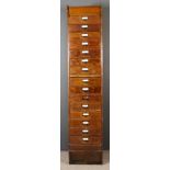 A 1920's Globe Wernicke Oak Tall Filing Chest, with panelled sides, fitted with a brushing slide and