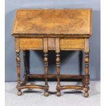 A Figured Walnut Bureau of 18th Century design, inlaid with panels of leaf scroll marquetry and