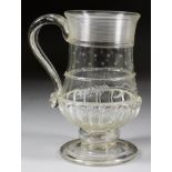 An English Glass Baluster Shaped "Coin" Tankard", circa 1790, with trailed rim, gadroon moulding