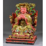 A Chinese Carved Wood, Painted and Gilt Decorated Figure of a Seated Official, 20th Century, on