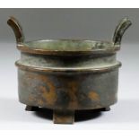 A Chinese Bronze Two-Handled Censer, of cylindrical form on three short feet, 3.5ins (8.9cm)