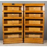 A Pair of Edwardian Globe Wernicke Oak Five-Tier Sectional Bookcases, the glazed rising fronts inset