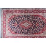 A Tabriz Carpet woven in colours with a bold central medallion and conforming spandrels filled