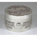 A Chinese Silvery Metal Circular Box and Cover, embossed with dragons and hearts, 3.5ins (9cm) x 2.