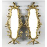 A Pair of Italian Gilt Wood Wall Mirrors, Late 19th/Early 20th Century, of Baroque form, the