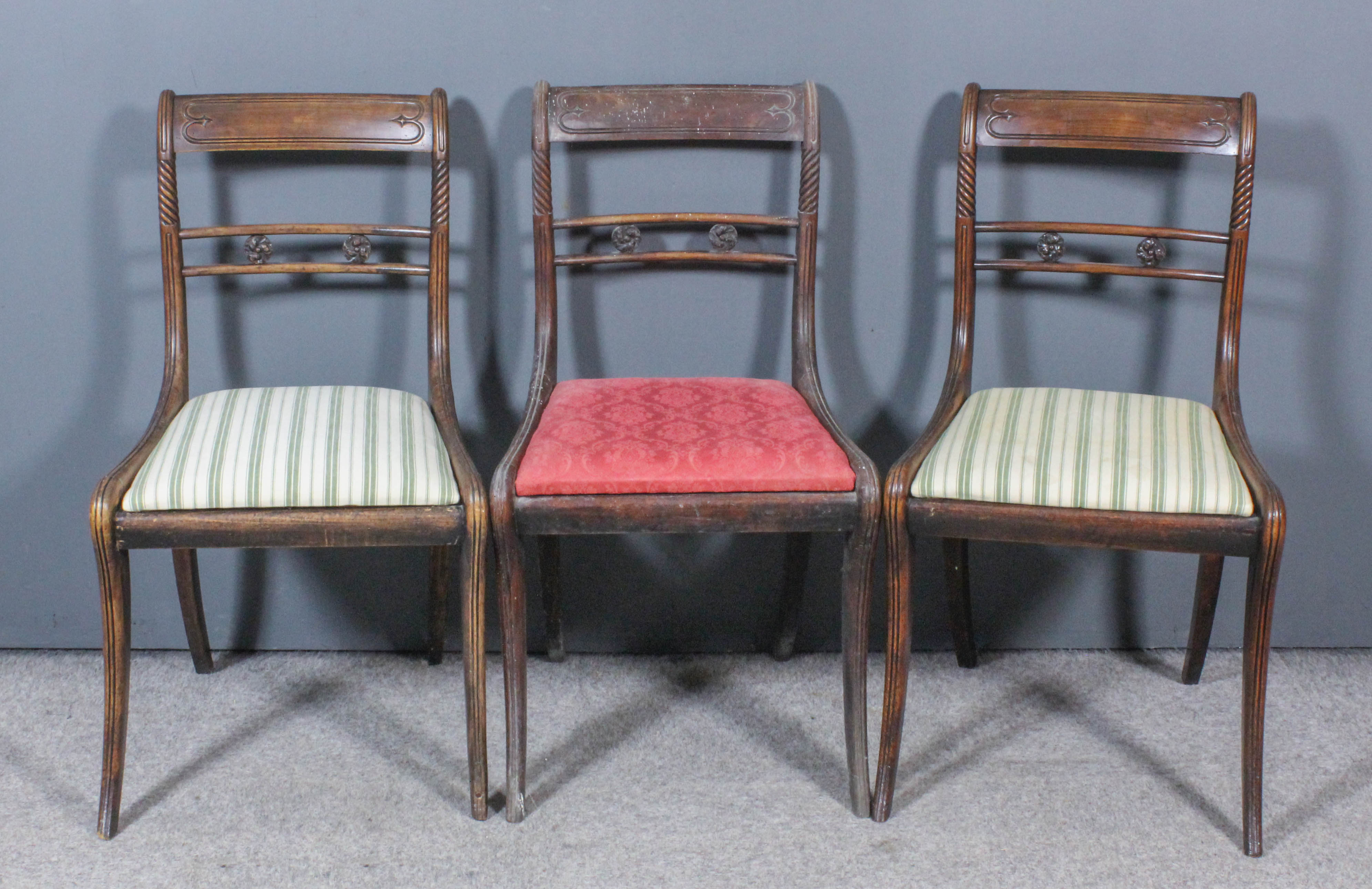 Three George III Mahogany Dining Chairs, with panelled crest rails, each with two turned paterae