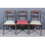 Three George III Mahogany Dining Chairs, with panelled crest rails, each with two turned paterae