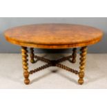 A Victorian Figured Walnut Circular Dining Table, the top veneered with eight segmented and