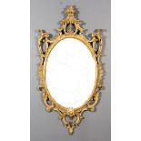 An Italian Gilt Framed Oval Wall Mirror of "George III" Design, the frame boldly fretted and