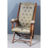 A Late Victorian Walnut and Brass Mounted Folding "Campaign" Armchair, the seat, back and arm pads