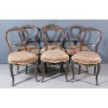 A Set of Six Victorian Walnut Balloon Back Drawing Room Chairs, the crest and splats carved with