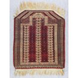 A Yomut Salachak Prayer Rug woven in colours with three pillars of hooked designs interspersed by