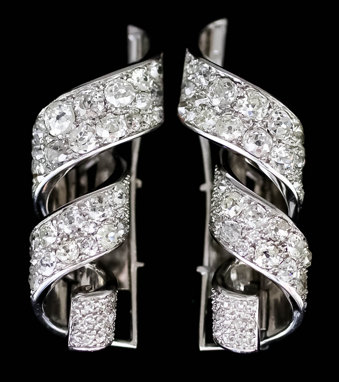 A Pair of Continental Diamond Clips, in 18ct white gold mount, of ribbon pattern, set with brilliant