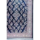 A Indian Carpet of Nain Design, woven in pastel colours with floral filled lozenge shaped