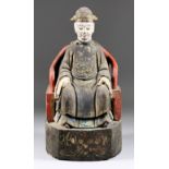 A Chinese Carved and Painted Wood Figure of an Official Seated in a Red Chair, 13ins (33cm) high
