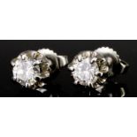A Pair of Solitaire Diamond Earrings, in 18ct white gold mount, for pierced ears, set with round