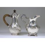 A Victorian Silver Baluster Shaped Hot Water Pot and a Victorian Silver Milk Jug, the hot water by