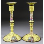 A Pair of George III Enamel Pillar Candlesticks, Late 18th Century, enamelled with vignettes of