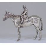 An Elizabeth II Cast Silver Model of a Horse and Jockey, import mark - makers mark indistinct,