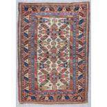 An Antique Shirvan Rug, woven in colours with three bold X-pattern guls centred by a cross fleury,