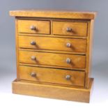A Late Victorian Mahogany Miniature Chest, with square top edge, fitted two short and three long