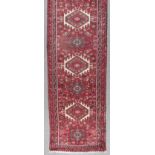 A Modern Balouch Runner, woven in colours with nine lozenge and cross pattern medallions with