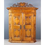 An 18th Century French Provincial Fruitwood Armoire, with bold fretted and carved cresting, now