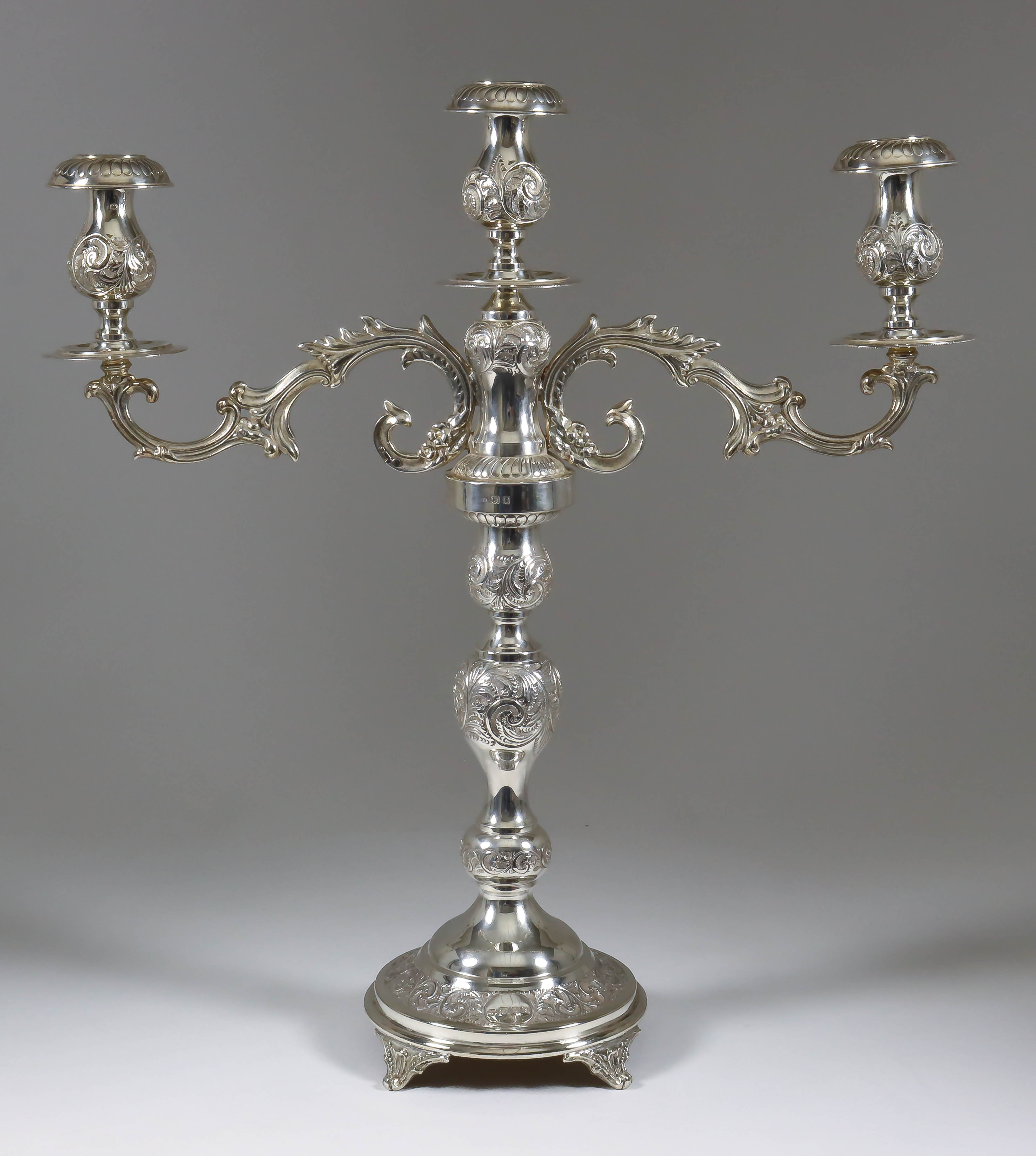 A George V Silver Three Light Candelabra, by Joseph Sweig, London 1920, the whole embossed with leaf