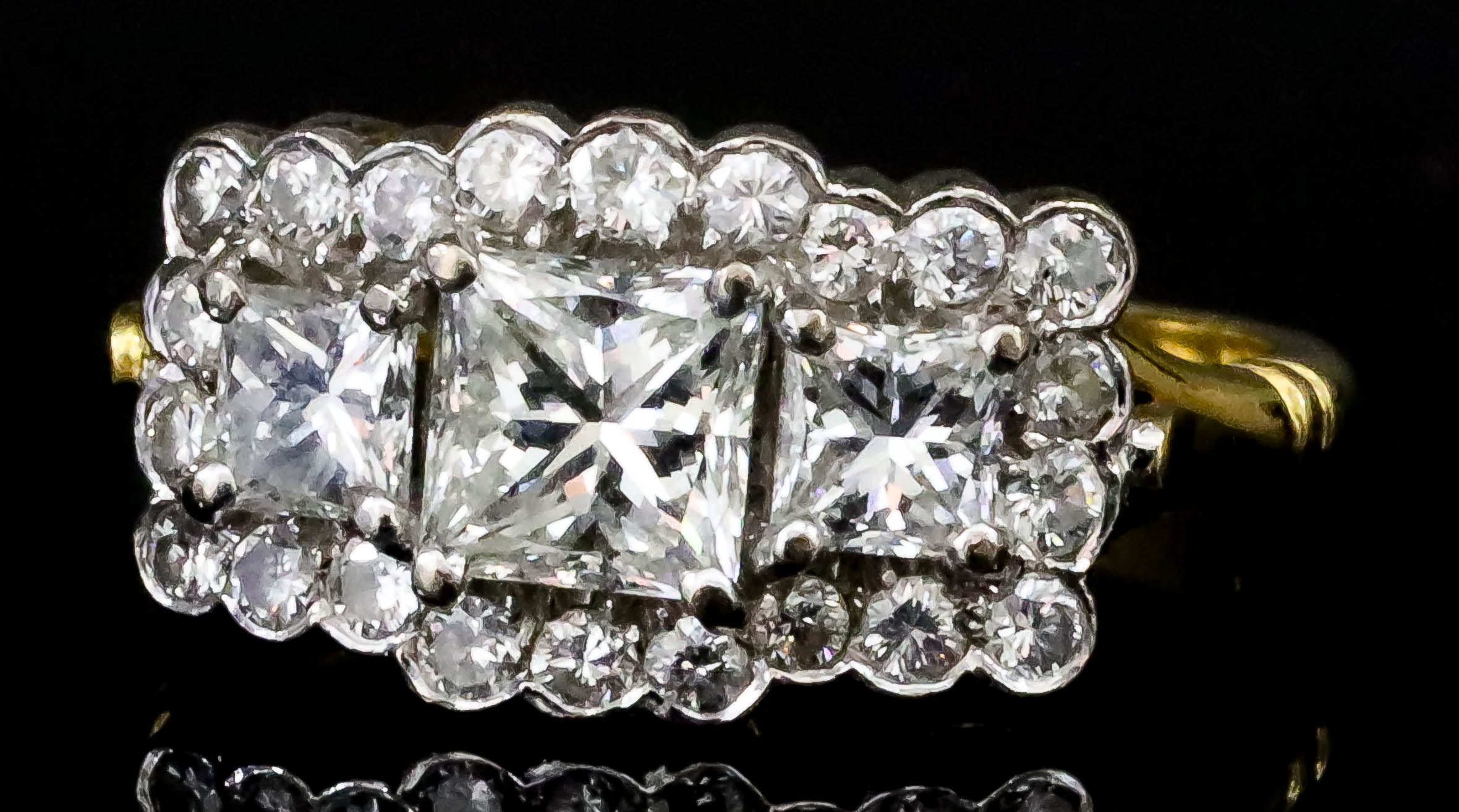 A Diamond Cluster Ring, Modern, in 18ct gold mount, the rectangular face set with three square