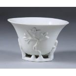 A Chinese Blanc de Chine Porcelain Dehua Libation Cup, Kangxi, 17th Century, the sides moulded