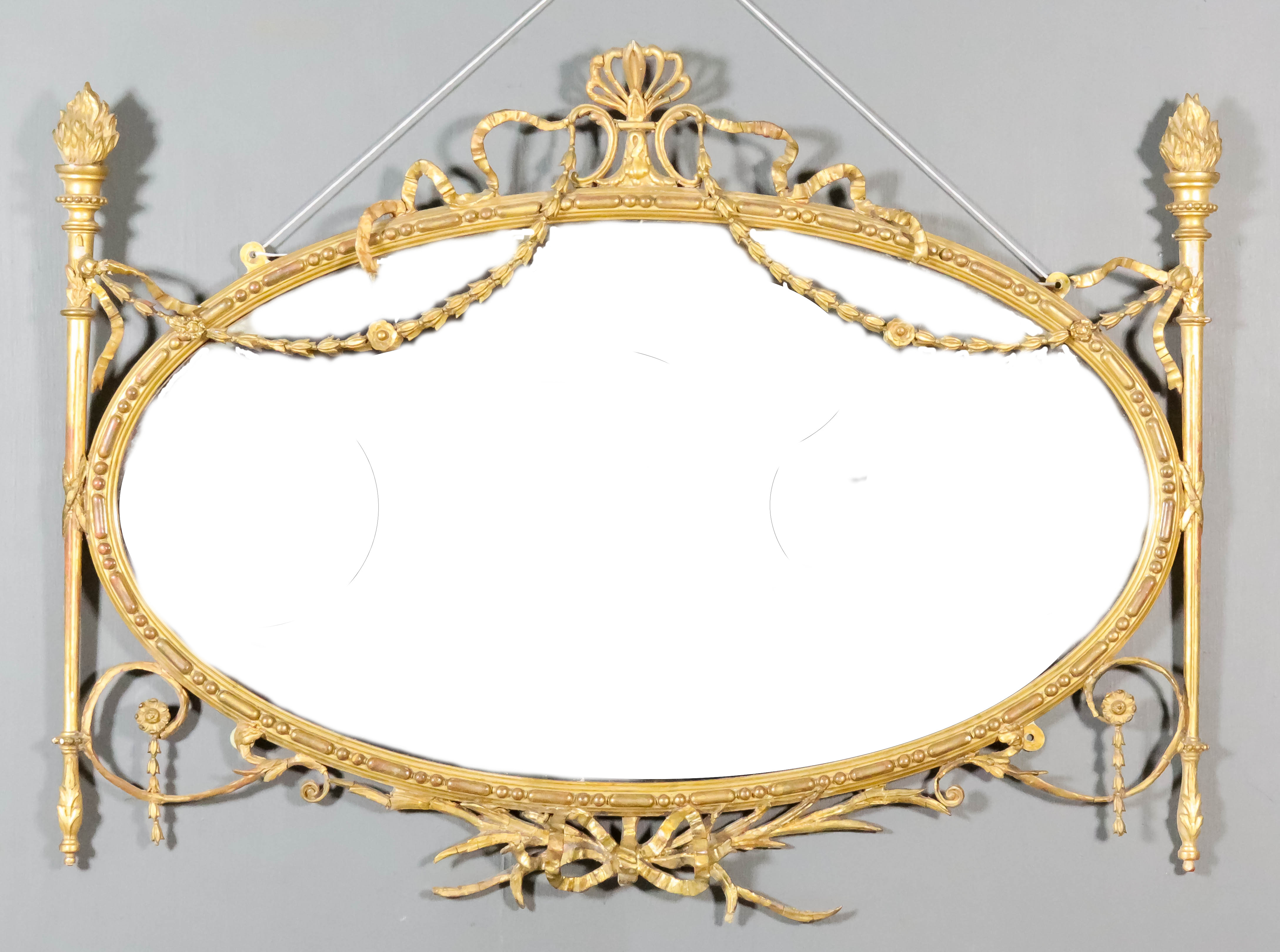 A Late 19th/Early 20th Century Gilt Framed Oval Wall Mirror, in the Neo-Classical manner, with