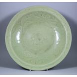 A Chinese Celadon Longquan Charger, Late Ming, the centre with moulded peony design, the rim with