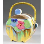 A Clarice Cliff Bon Jour Biscuit Barrel, circa 1933, painted with "Delicia Pansies" pattern, with