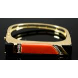 A 14ct Gold and Hard Stone Stiff Bracelet, Modern, of Art Deco design, the face set with red and