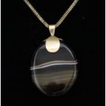 A Gold Coloured Metal Mounted Oval Polished Banded Agate Pendant, 60mm x 40mm, and a 400mm gold