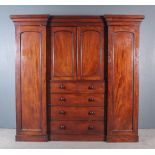 A Victorian Mahogany Breakfront Wardrobe, with moulded cornice, now fitted two central shelves