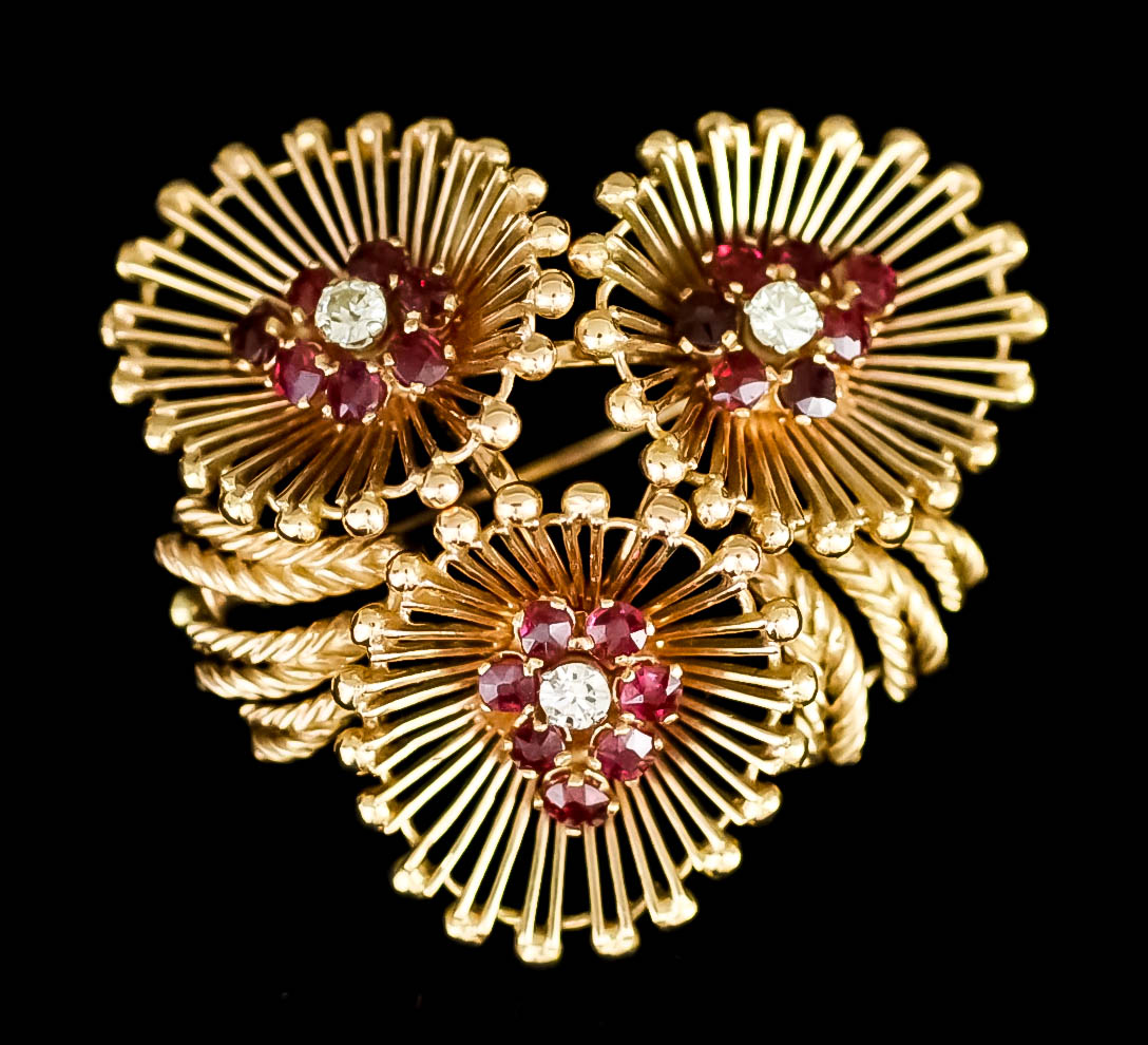 An 18ct Gold Diamond and Ruby Brooch, Modern, of triple flowerhead pattern, set with three small