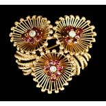 An 18ct Gold Diamond and Ruby Brooch, Modern, of triple flowerhead pattern, set with three small