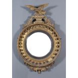 A 19th Century Gilt Framed Circular Convex Wall Mirror, with eagle and leaf cresting and