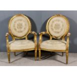 A Pair of French Gilt Framed Fauteuil of "Louis XVI" Design, the oval backs with moulded and
