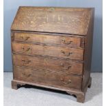 A George III oak bureau, the slope enclosing pigeon holes, small central cupboard and six small