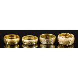 Four 18ct Gold Wedding Bands, one of plain form, two with engraved faces, and one of tricolour gold,