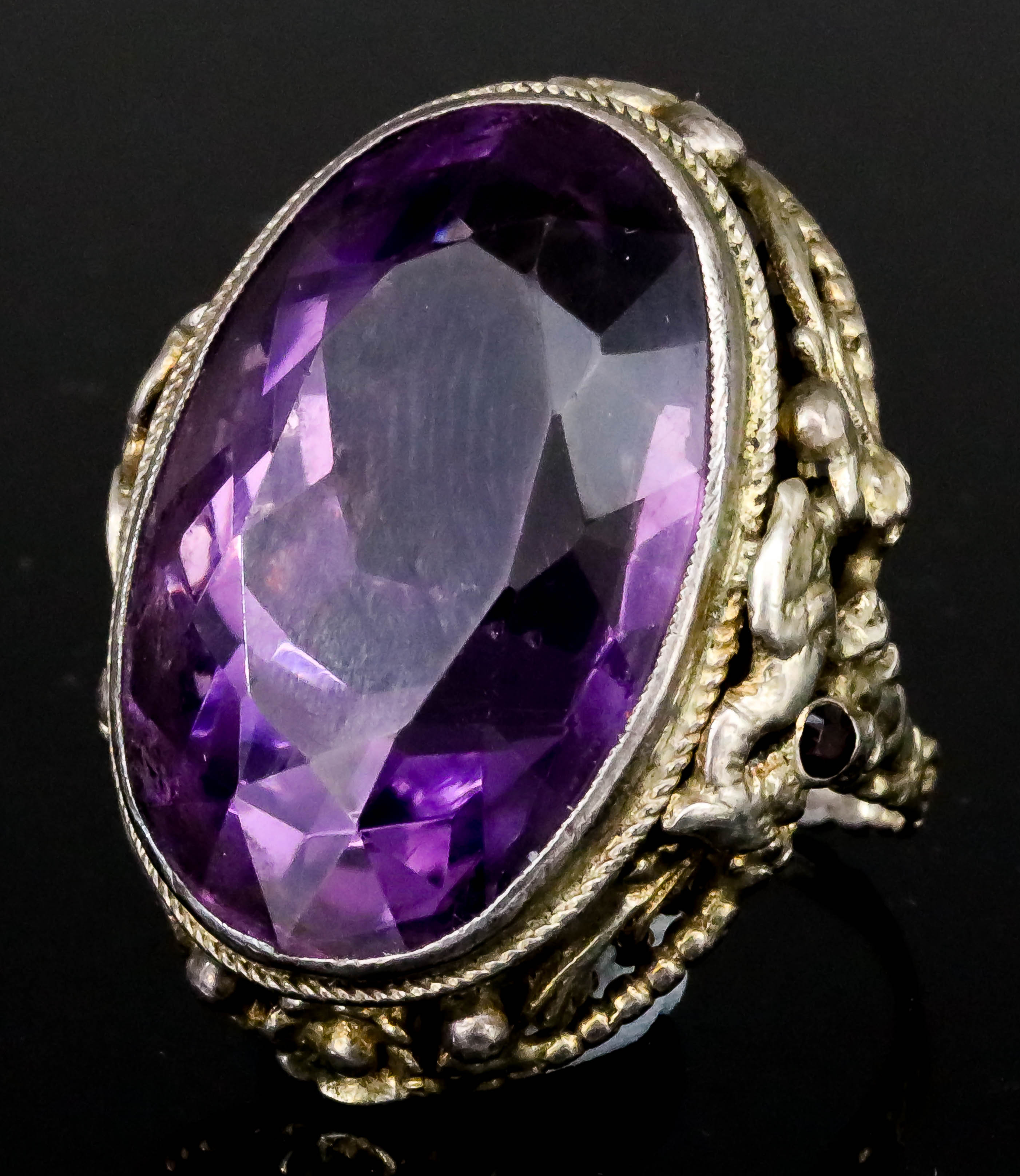 An Amethyst Dress Ring, in silvery metal mount, set with a faceted oval amethyst, 18mm x 28mm, the